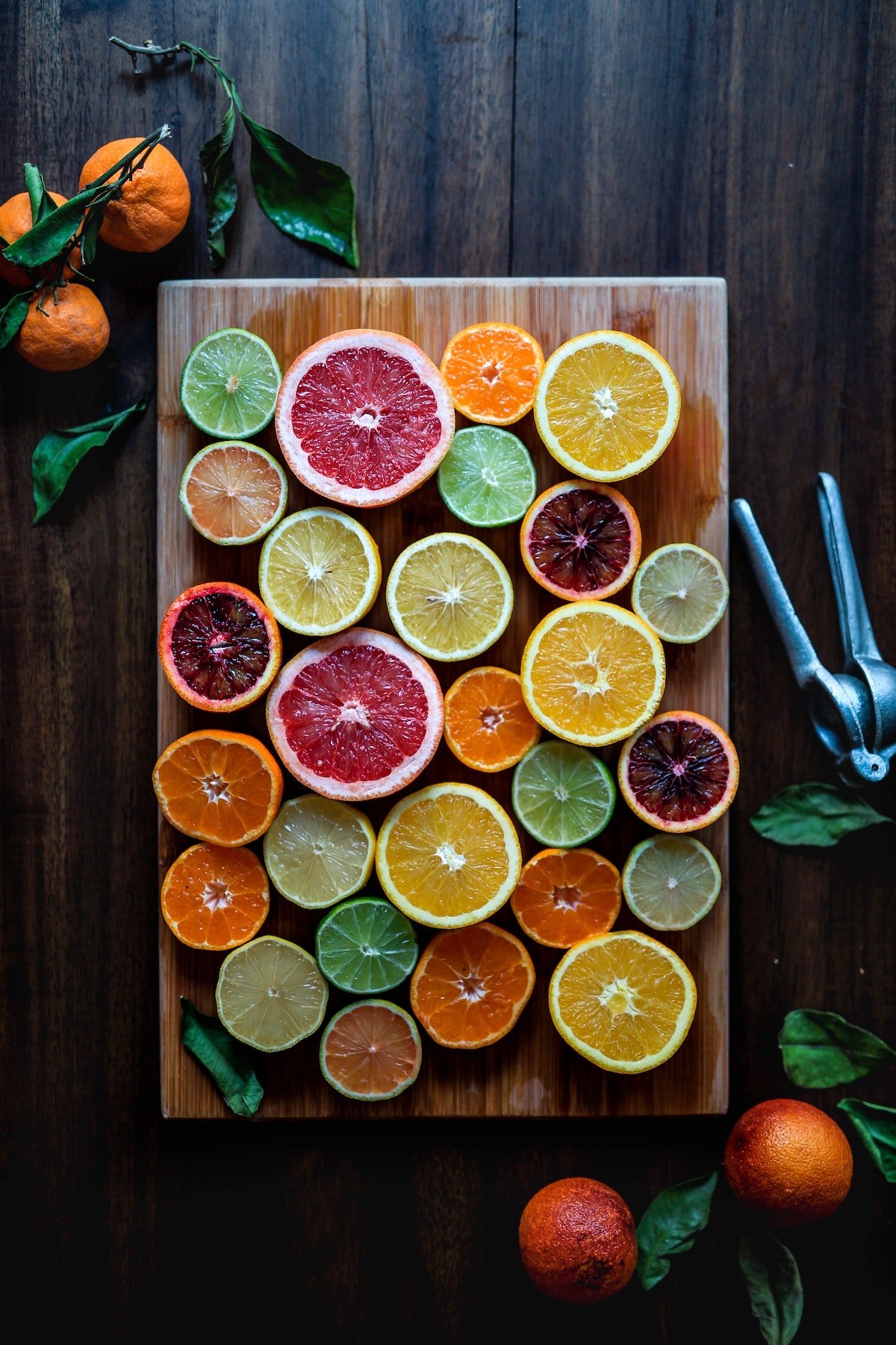 Different citrus fruit on cutting board to represent possible snacks for moms.